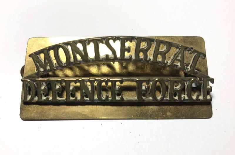 MONTSERRAT / DEFENCE FORCE brass shoulder title.