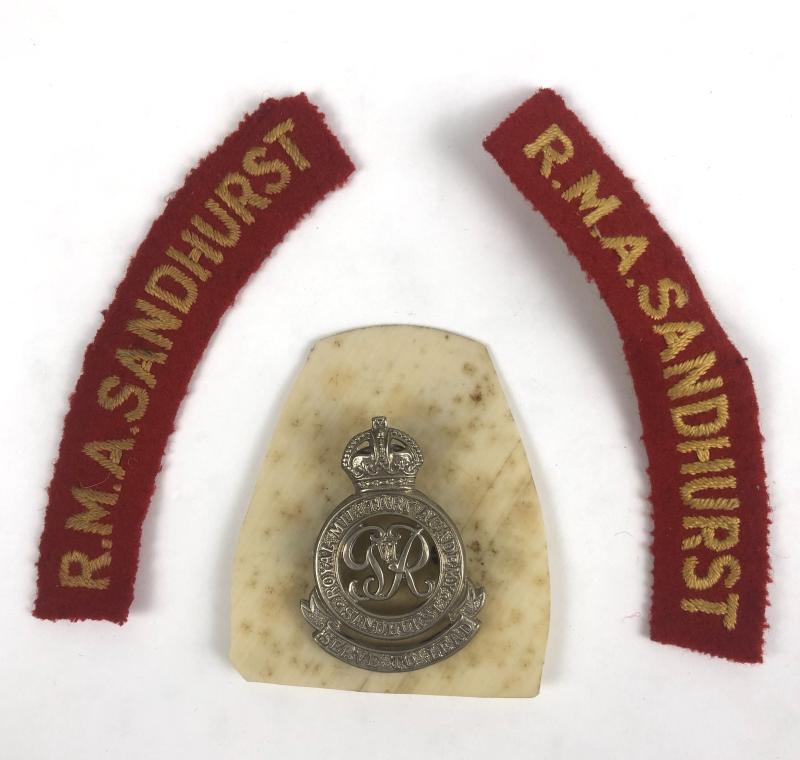 RMA Sandhurst Officer Cadet's cap badge and pair of cloth soulder titles.